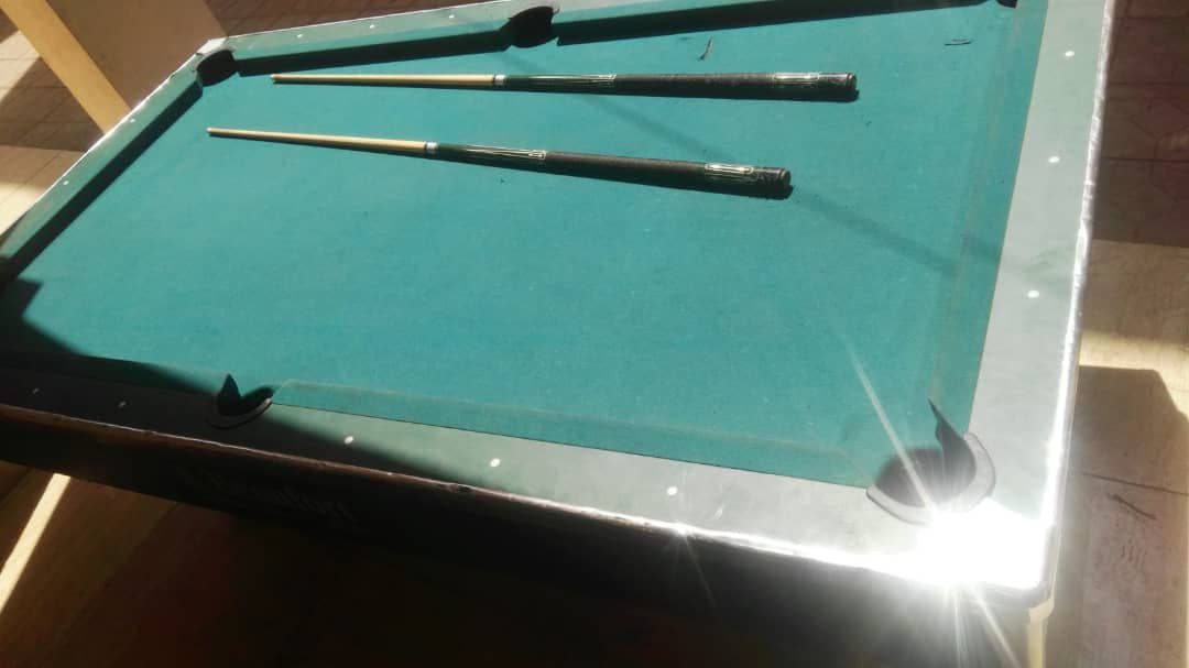 Pool table with cues and
