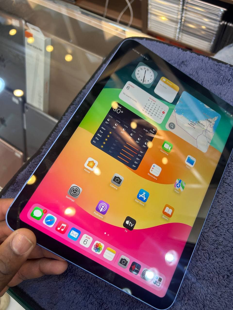 Person holding ipad with various