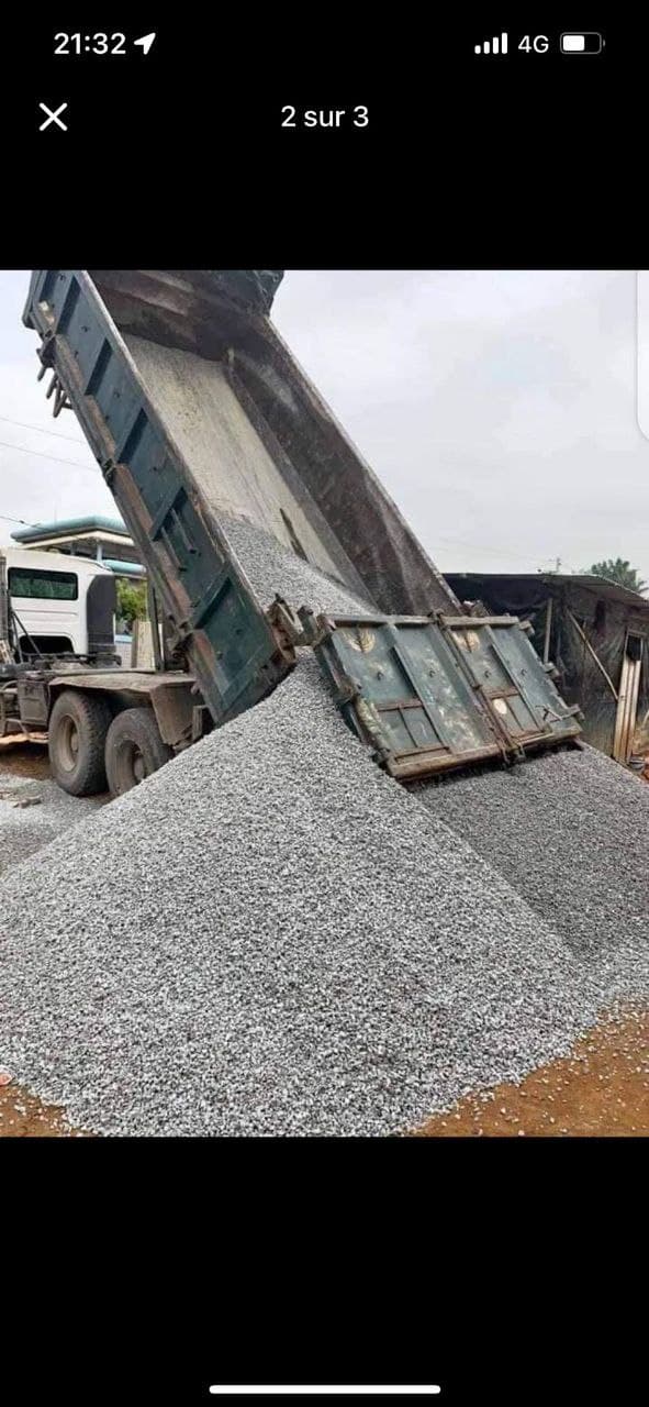 Dump truck dumping gravel pile