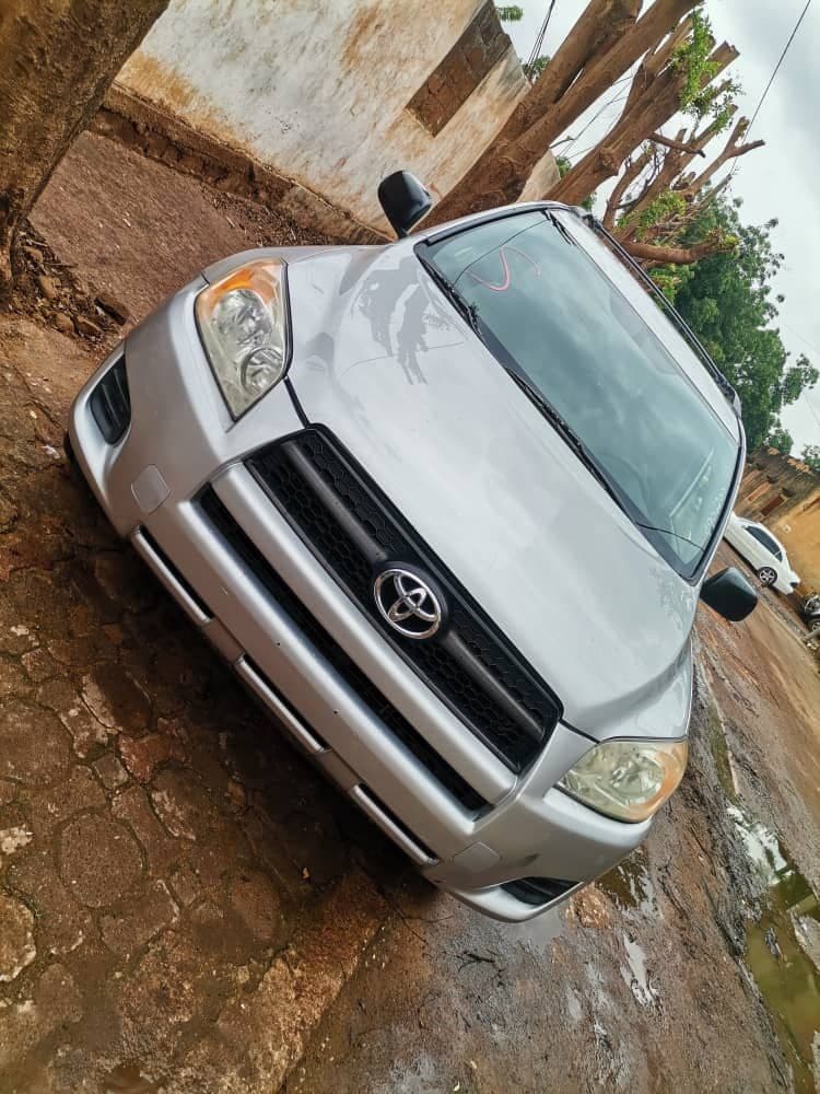 Silver car parked dirt road